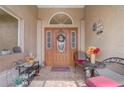 Welcoming front porch with seating, decor, and double doors with decorative glass at 2800 Woodsmere Ct, Kissimmee, FL 34746