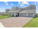 Charming two-story home featuring a three-car garage and beautifully landscaped front yard at 3179 Sailing Pier Ave, Winter Garden, FL 34787