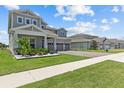 Charming two-story home featuring a three-car garage and beautifully landscaped front yard at 3179 Sailing Pier Ave, Winter Garden, FL 34787