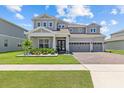 Charming two-story home featuring a three-car garage and beautifully landscaped front yard at 3179 Sailing Pier Ave, Winter Garden, FL 34787