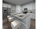 Kitchen with an island, granite countertops, stainless steel appliances, and modern barstool seating at 3674 Portsmouth Ln, Haines City, FL 33844