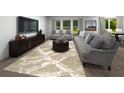 Cozy living room with neutral-toned sofas, a decorative rug, and a large TV screen at 3674 Portsmouth Ln, Haines City, FL 33844