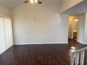Bright living room boasting a ceiling fan, high ceiling, and wood flooring, creating a spacious and welcoming atmosphere at 3713 S Lake Orlando Pkwy # 6, Orlando, FL 32808