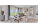 Elegant dining room with seating for six, stylish decor, and a view of the outdoors at 5174 Masser Rd, St Cloud, FL 34772