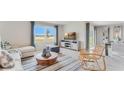 Open-concept living room with natural light, a cozy sofa, and modern furnishings at 5174 Masser Rd, St Cloud, FL 34772
