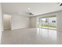 Spacious living room with sliding glass doors providing lots of natural light and tile flooring at 5846 Sw 80Th Ln, Ocala, FL 34476
