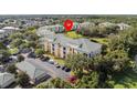 Well-situated, bright, and inviting apartment building with a well-manicured lawn and a backdrop of lush, mature trees at 8816 Dunes Ct # 303, Kissimmee, FL 34747