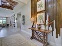 Elegant foyer with decorative wood wall, stylish console table, and views into the living area at 9979 Winnington St, Orlando, FL 32832