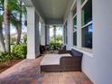 Spacious covered patio with outdoor seating area and brick flooring, perfect for enjoying the outdoors at 9979 Winnington St, Orlando, FL 32832