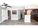 Open-concept living room with plank flooring, gray walls and an open pass-through to the kitchen at 1019 S Hiawassee Rd # 3811, Orlando, FL 32835