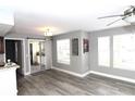 Bright living room with modern gray walls, plank flooring, large windows and sliding glass door at 1019 S Hiawassee Rd # 3811, Orlando, FL 32835