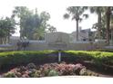 Community entrance sign landscaped with green shrubbery and colorful flowers in the Tradewinds Metrowest Condominium at 1019 S Hiawassee Rd # 3811, Orlando, FL 32835