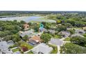 An aerial view of a neighborhood with mature trees and a lake in the background at 1103 Lake Legro Ct, Orlando, FL 32835