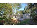 Spacious backyard featuring mature trees, a patio, and views of natural Florida landscape at 139 Stoney Ridge Dr, Longwood, FL 32750