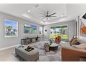 Bright living room with large windows, modern furniture, and neutral color palette at 19105 Planetree St, Orlando, FL 32827