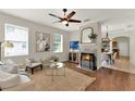 Bright living room with hardwood floors, a ceiling fan, and a stylish fireplace at 2009 E Grant St, Orlando, FL 32806