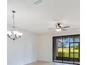Bright room with a ceiling fan and sliding glass doors that offers great views of the lawn at 20610 Maxim Pkwy, Orlando, FL 32833
