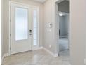 Bright foyer with large glass front door, tile flooring, and neutral paint at 2066 Cresswell St, Ocoee, FL 34761