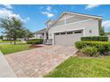 Beautiful single-story home with brick driveway and attached two-car garage at 2066 Cresswell St, Ocoee, FL 34761