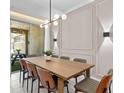 Comfortable dining area with modern light fixture and an outdoor view at 2460 Reading Trl, Kissimmee, FL 34746