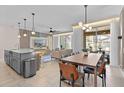 Open concept dining and living area with modern lighting, stylish furnishings and easy access to the pool at 2460 Reading Trl, Kissimmee, FL 34746