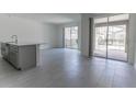 Open living area with tile flooring, sliding glass doors that offers great natural light and backyard access at 2460 Reading Trl, Kissimmee, FL 34746