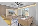 Bright living room with comfortable seating, an entertainment center, and access to the pool at 2460 Reading Trl, Kissimmee, FL 34746