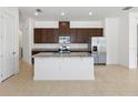 Bright kitchen features stainless steel appliances, granite countertops, and a large center island at 2571 Yellow Brick Rd, St Cloud, FL 34772
