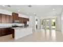 Bright open kitchen with stainless steel appliances, an island, and easy access to the backyard at 2571 Yellow Brick Rd, St Cloud, FL 34772