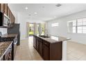 Spacious kitchen features granite countertops, stainless steel appliances, and ample counter space at 2571 Yellow Brick Rd, St Cloud, FL 34772