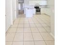 An eat-in kitchen features white cabinets, stainless appliances, and a large countertop at 2816 Club Cortile Cir # A, Kissimmee, FL 34746