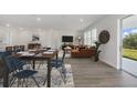 Open floor plan with modern furnishings and decor, dining table, and sliding doors to the exterior at 3004 Water Clover Ct, Apopka, FL 32712
