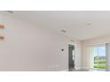 Bright living room with tile flooring, sliding glass doors and neutral wall colors at 3110 Areca Ave, New Smyrna Beach, FL 32168