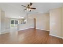 Open-concept living room with tile flooring, ceiling fan, and a view of the kitchen at 3313 Buckland St, Deltona, FL 32738