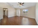 Spacious living room with wood-look tile flooring, ceiling fan, and natural light at 3313 Buckland St, Deltona, FL 32738