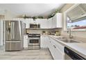 Well-lit kitchen with stainless steel appliances, ample cabinet space, and modern sink at 3531 Reston Dr, The Villages, FL 32162