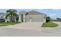Well-maintained single-Gathering home featuring a spacious driveway leading to a two-car garage, surrounded by green lawns at 3866 Cabo Rojo Dr, St Cloud, FL 34772
