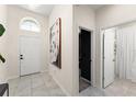 Inviting entryway featuring tiled flooring, a modern light fixture and an adjacent art piece at 3866 Cabo Rojo Dr, St Cloud, FL 34772