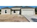 Newly constructed home with a neutral facade, two-car garage, and a clean, modern aesthetic at 5381 Sw 128Th Street Rd, Ocala, FL 34473