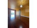 Spacious living room featuring hardwood floors and stylish chandelier at 6434 Cava Alta Dr # 401, Orlando, FL 32835