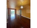 Spacious living room featuring hardwood floors and stylish chandelier at 6434 Cava Alta Dr # 401, Orlando, FL 32835