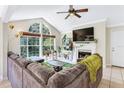 Bright living room with large windows, fireplace, and a comfortable sectional sofa at 698 Roaring Dr # 382, Altamonte Springs, FL 32714