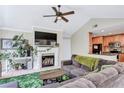Inviting living room with fireplace, large screen TV, vaulted ceilings, and seamless flow to the kitchen at 698 Roaring Dr # 382, Altamonte Springs, FL 32714