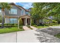 Beautiful townhome featuring lush landscaping, mature trees, and a serene view, creating a welcoming atmosphere at 11686 Water Run Aly, Windermere, FL 34786