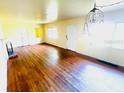 Open living room featuring hardwood floors, bright natural light, and classic chandelier fixture at 1403 N Fern Creek Ave, Orlando, FL 32803