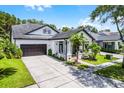 A beautiful front view of a home with well-maintained landscaping, a spacious driveway, and a two-car garage at 14213 Southern Red Maple Dr, Orlando, FL 32828
