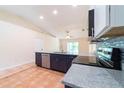 Spacious kitchen featuring stainless steel appliances, granite countertops, and an eat-in island at 1530 Monica St, Deltona, FL 32725