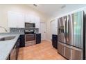 Bright kitchen with stainless steel appliances, white cabinets and blue backsplash at 1530 Monica St, Deltona, FL 32725