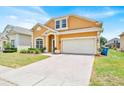 Well-maintained home with a brick driveway, two-car garage, and tidy landscaping at 233 Cadiz Loop, Davenport, FL 33837
