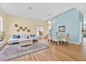Bright and airy living room featuring hardwood floors, contemporary furniture, and plenty of natural light at 233 Cadiz Loop, Davenport, FL 33837